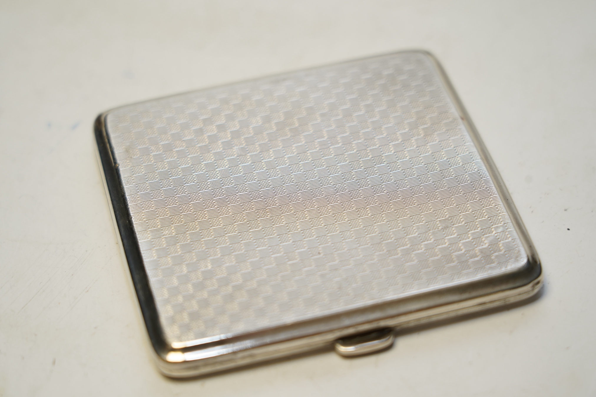 Two early 20th century silver mounted square cigarette boxes, largest 10.1cm, a similar silver cigarette case and three other silver items. Condition - fair to poor